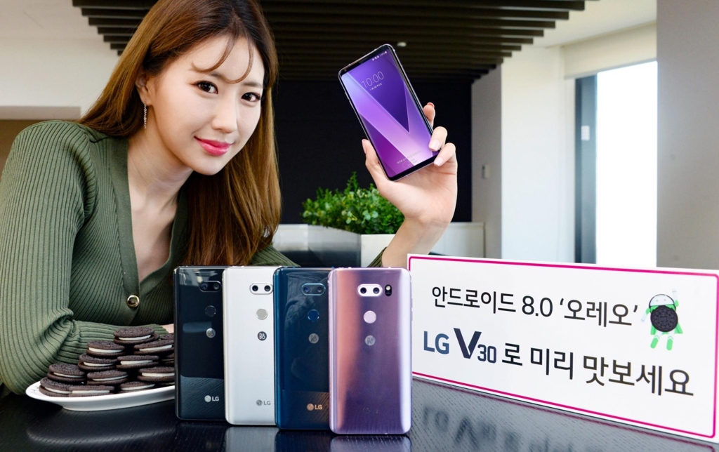 A model poses with V30 smartphones in this photo released by LG Electronics on Nov. 2, 2017. (Yonhap)