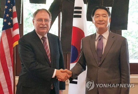 In this photo provided by the foreign ministry, South Korea's chief negotiator, Chang Won-sam (R), shakes hands with his U.S. counterpart, Timothy Betts, in Honolulu, Hawaii, on March 7, 2018. (Yonhap) 