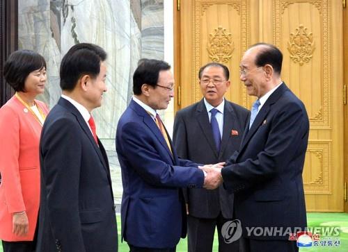 This photo, provided by North Korea's news agency on Sept. 20, 2018, shows Kim Yong-nam (R), the president of the Presidium of the Supreme People's Assembly, meeting visiting South Korean politicians, including Lee Hae-chan (C), the chief of South Korea's ruling party. (Yonhap)