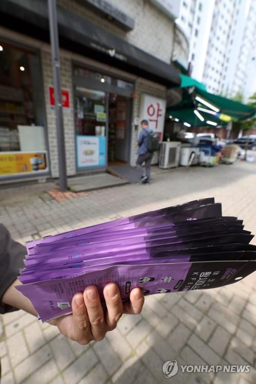 A customer holds a bundle of masks for himself and his family after purchasing them at a drugstore in Gwangju, 329 kilometers south of Seoul, on June 1, 2020. No standing in line was necessary. (Yonhap)