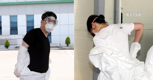 Medical workers take off protective clothing at Cheongju's Sangdang Community Health Center on June 10, 2020. (Yonhap)
