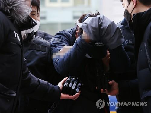 A man accused of fatally attacking his former girlfriend's family arrives at the Seoul Eastern District Court on Dec. 12, 2021, to attend his arrest warrant hearing. (Yonhap)
