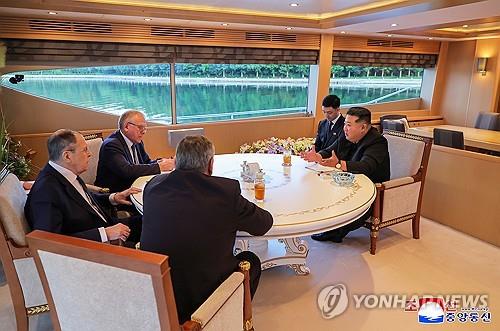 This image, published by the Korean Central News Agency on July 13, 2025, shows North Korean leader Kim Jong-un (R) holding a meeting with Russian Foreign Minister Sergei Lavrov (L) and other Russian officials on July 12, 2025. (For Use Only in the Republic of Korea. No Redistribution) (Yonhap)