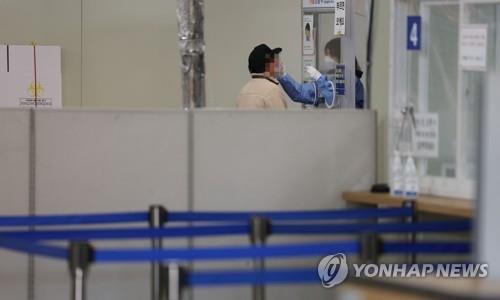 Un agent de santé effectue un test de dépistage du nouveau coronavirus dans un centre de dépistage situé dans le quartier de Songpa, à Séoul, le 30 novembre 2022.