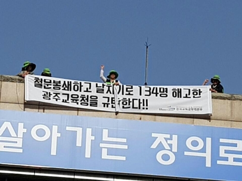옥상에서 시위하는 돌봄교사들
