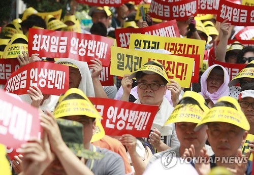 '최저임금 인상 반대'(서울=연합뉴스) 한종찬 기자 = 지난해 7월 12일 서울 여의도 국민은행 앞에서 소상공인연합회 주최로 열린 최저임금 인상저지 소상공인 결의대회에서 참가자들이 피켓을 들고 있다. 2016.7.12saba@yna.co.kr
