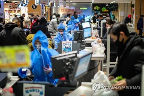 방호복 입은 계산원들이 일하고 있는 중국 선양의 한 슈퍼마켓