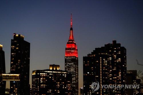 조 바이든 미 대통령 당선인의 취임식 전날인 19일 밤 코로나19 희생자를 기리며 붉을 밝힌 뉴욕의 엠파이어 스테이트 빌딩 [AP=연합뉴스자료사진]