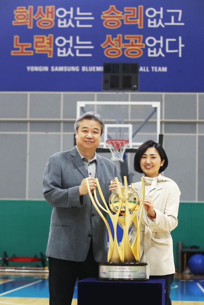 우승 트로피와 함께 포즈를 취한 임근배 감독(왼쪽)과 아내 홍제옥 씨.