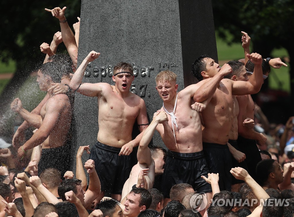 US-NAVAL-ACADEMY-FRESHMAN-CLIMB-GREASED-MONUMENT-IN-ANNUAL-RITE-