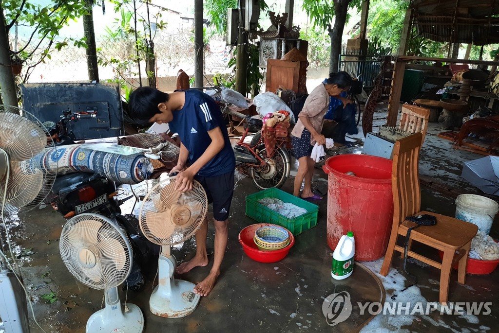 This Xinhua photo shows residents checking their belongings at a local community in Quang Tri Province in central Vietnam on Oct. 20, 2020, after floods caused by heavy downpours that left at least 105 people dead. (Yonhap) 