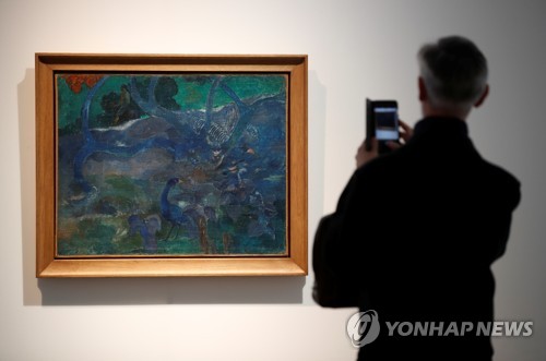 프랑스 파리 경매사에서 한 관람객이 고갱의 해당 작품을 사진으로 찍고 있다. (로이터=연합뉴스)