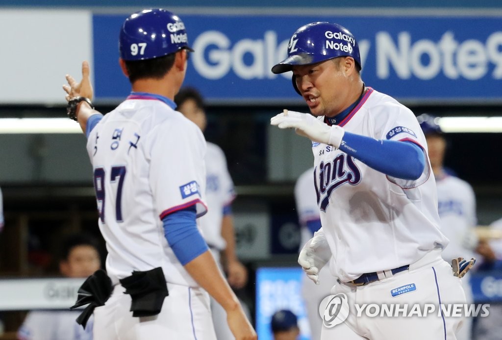 In this file photo from Sept. 6, 2018, Park Han-yi of the Samsung Lions (R) is greeted at the home plate by his first base coach, Kang Myung-gu, after hitting a solo home run against the Doosan Bears in the bottom of the second inning of a Korea Baseball Organization regular season game at Daegu Samsung Lions Park in Daegu, 300 kilometers southeast of Seoul. (Yonhap)