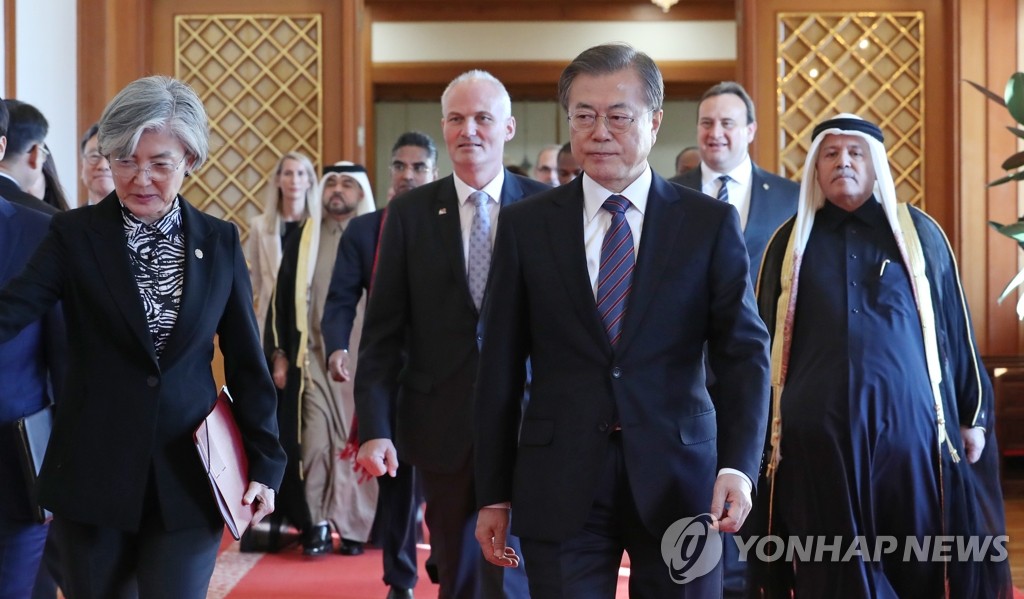 President Moon Jae-in and Foreign Minister Kang Kyung-wha (L) walk into a Cheong Wa Dae meeting room after receiving the credentials of 12 new foreign ambassadors on Nov. 14, 2019. (Yonhap)
