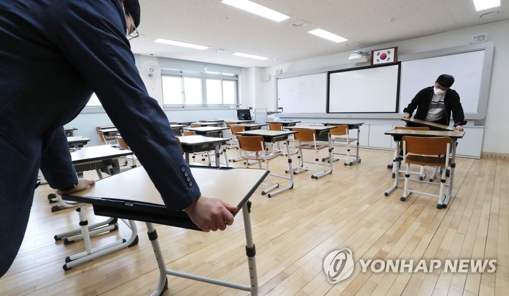 School staff rearrange seats at a high school in the central city of Sejong on May 1, 2020. (Yonhap)