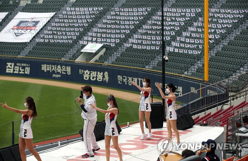 In this file photo from May 31, 2020, cheerleaders for the Doosan Bears perform on a stage in front of empty seats at Jamsil Baseball Stadium in Seoul during a Korea Baseball Organization regular season game between the Bears and the Lotte Giants. (Yonhap)