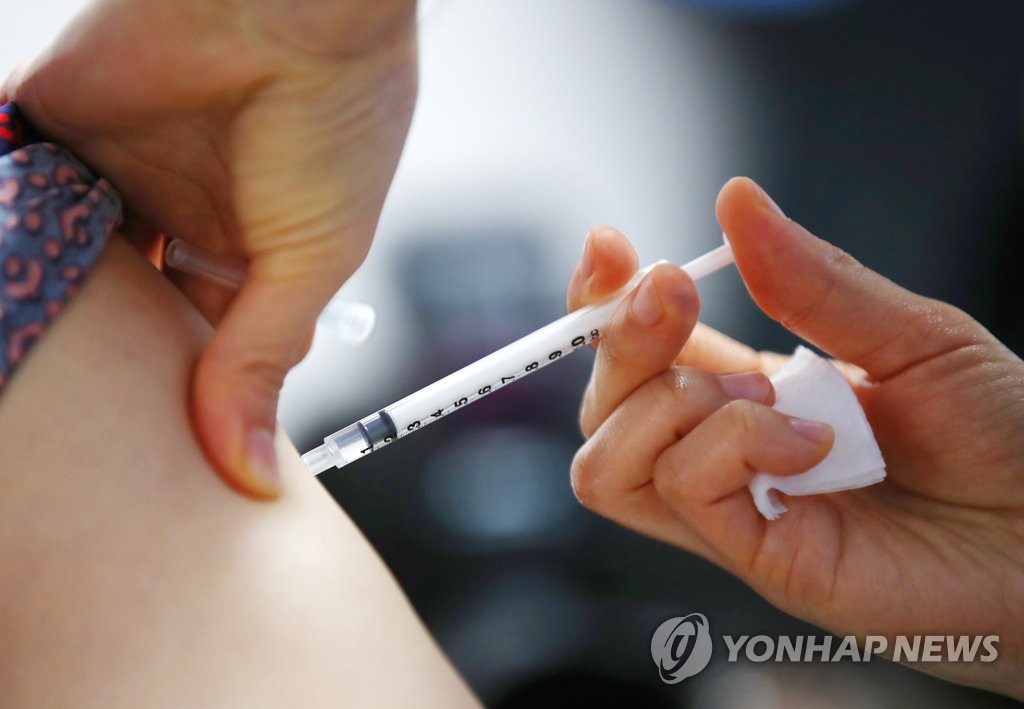 A worker at a nursing home in western Seoul receives AstraZeneca's COVID-19 vaccine on March 2, 2021. (Yonhap)