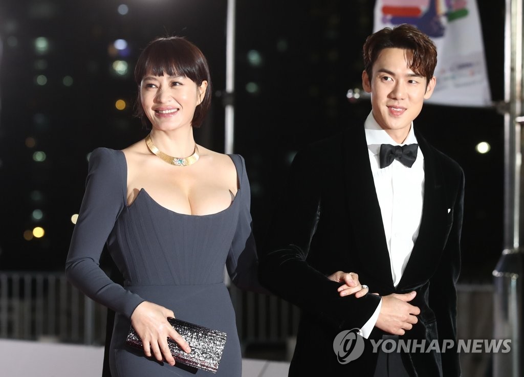 Actors Kim Hye-soo (L) and Yoo Yeon-seok, host of the 42nd Blue Dragon Awards, enter the red carpet of the ceremony held at KBS Hall in Seoul on Nov. 26, 2021. (Yonhap)