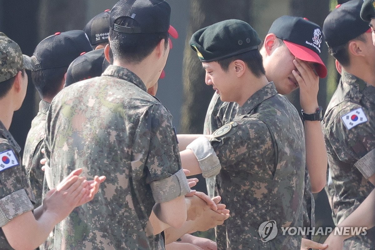 BTS member Jin hugs fellow soldiers in a brief farewell ceremony to mark the completion of his military duty at the 5th Army Infantry Division in Yeoncheon, 61 kilometers north of Seoul, on June 12, 2024. (Yonhap)