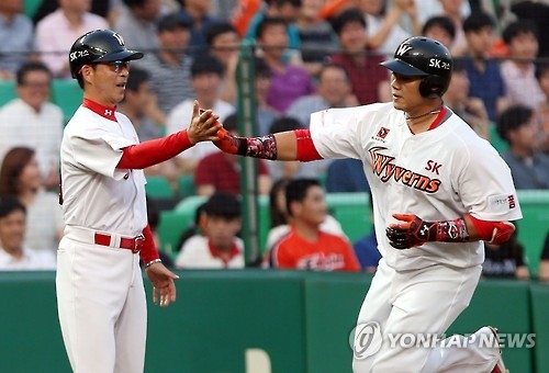In this file photo taken on July 7, 2016, Choi Seung-jun of the SK Wyverns (R) celebrates a home run against the Hanwha Eagles in a Korea Baseball Organization regular season game at Incheon SK Happy Dream Park in Incheon. (Yonhap)