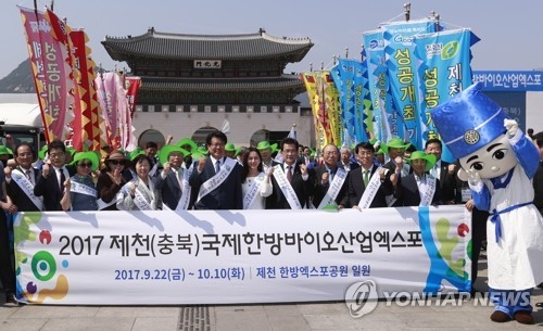 North Chungcheong Gov. Lee Si-jong (4th from R), actress Park Joo-mi (5th from R) and other participants pose for a photo during an event at Gwanghwamun Plaza in Seoul on June 14, 2017, to promote the International Korean Medicine Bio Industry Expo that will be held in Jecheon, a city in South Korea's central province of North Chungcheong from Sept. 22-Oct. 10. (Yonhap)