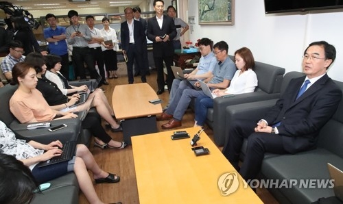 This photo taken on July 3, 2017, shows new Unification Minister Cho Myoung-gyon (R) speaking to reporters after taking office. (Yonhap)