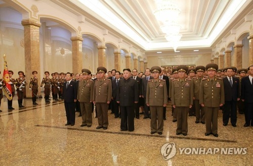 In this photo, provided by the Korean Central News Agency (KCNA), North Korean leader Kim Jong-un, 4th from (L) in front row, stands abreast with key officials at the Kumsusam Memorial Hall to pay respects to Kim Il-sung, his grandfather and late founder of the regime, on the 23rd anniversary of his death, on July 8, 2017. (Yonhap) (For Use Only in the Republic of Korea. No Redistribution) 
