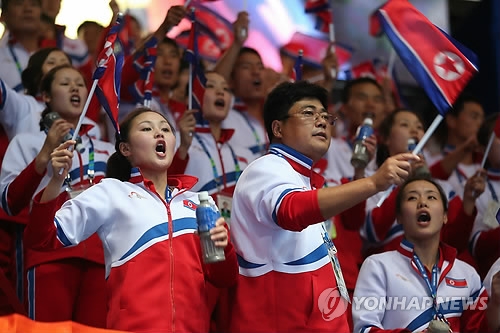 This file photo taken on Sept. 27, 2014, shows North Koreans supporting their athletes in the men's wrestling competition at the Asian Games in Incheon. (Yonhap)