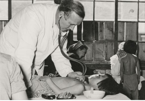This undated photo provided by the defense ministry shows a German doctor examining a patient at a German hospital set up in Busan in 1954 after the Korean War. (Yonhap)