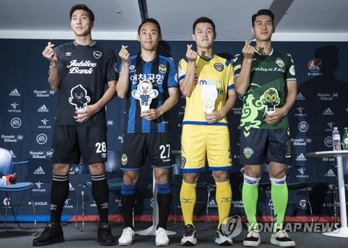 This file photo taken on July 3, 2018, shows K League players Yun Young-sun, Moon Seon-min, Ju Se-jong and Lee Yong (from L) posing for a photo during a media event at the Korea Football Association House in Seoul. (Yonhap) 