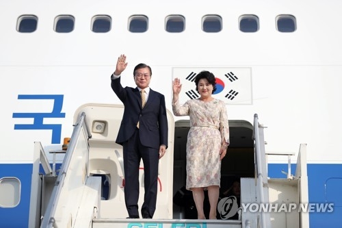 South Korean President Moon Jae-in and his wife, Kim Jung-sook, wave after arriving in New Delhi on July 8, 2018, for a four-day state visit that will include a bilateral summit with Indian Prime Minister Narendra Modi. (Yonhap)