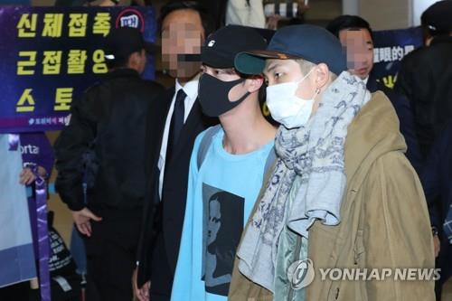 BTS members RM (L) and Jin return home with other members through Incheon International Airport on Oct. 24, 2018. (Yonhap)