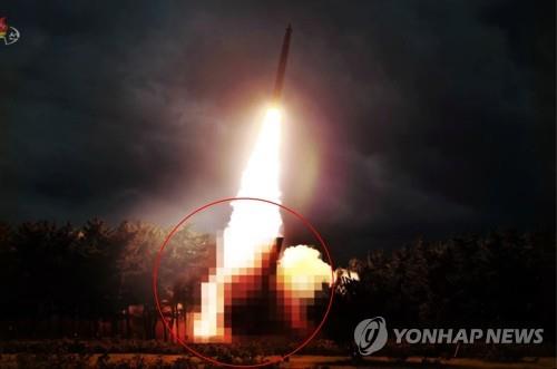 This photo captured from Pyongyang's state TV on Aug. 1, 2019, shows the test-firing of what North Korea claims to be a newly developed large-caliber multiple launch guided rocket system with the launcher part blurred out. (For Use Only in the Republic of Korea. No Redistribution) (Yonhap)
