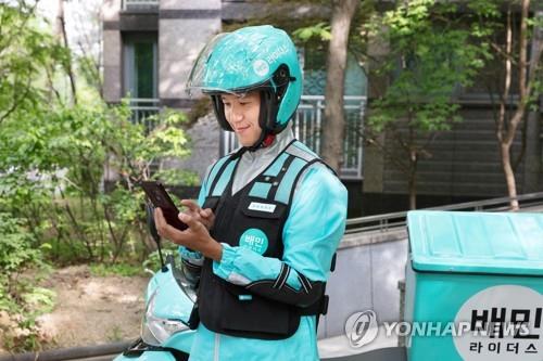 This photo, provided by Woowa Brothers, shows a Baemin deliveryman. (NOT FOR SALE). (Yonhap)