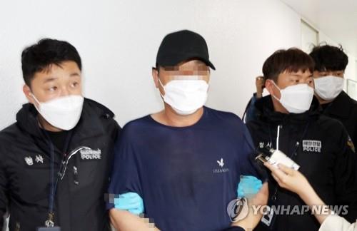 A Chinese man is taken to the Taean Coast Guard station in Taean, South Chungcheong Province, on May 27, 2020, after illegally entering South Korea on a boat. (Yonhap)
