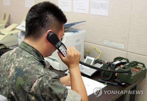 This undated file photo shows a South Korean officer using a military hotline with North Korea. (Yonhap) 
