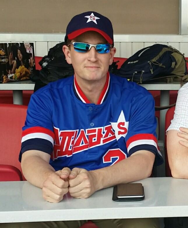 Thomas St. John, a former baseball journalist and current university professor teaching South Korean baseball history, poses at a baseball stadium in this 2019 photo, provided by St. John. (PHOTO NOT FOR SALE) (Yonhap)
