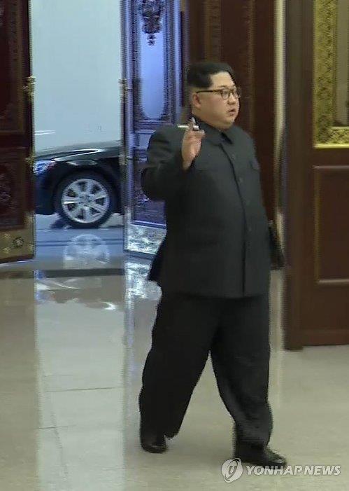 North Korea's top leader Kim Jong-un is seen holding a cigarette in this photo captured from the North's Korean Central TV on Dec. 13, 2017, as he attended the 8th Conference of Munitions Industry in Pyongyang a day earlier. North Korea launched a nationwide anti-smoking campaign last year, but outside watchers say the smoking rate is actually increasing, partly due to Kim's smoking habit being frequently shown in public. (For Use Only in the Republic of Korea. No Redistribution) (Yonhap)