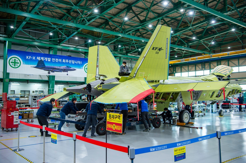 Workers of the Korea Aerospace Industries (KAI) assemble a prototype of South Korea's first indigenous fighter jet KF-X at its plant in the southeastern city of Sacheon on Feb. 24, 2021, in this photo provided by the arms procurement agency. (PHOTO NOT FOR SALE) (Yonhap)
