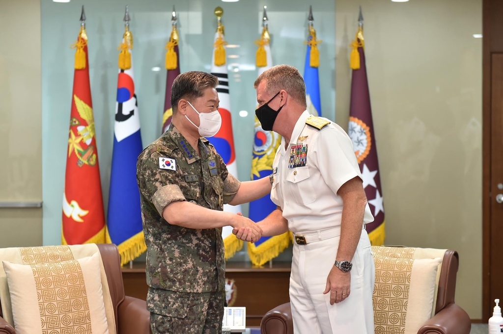 Joint Chiefs of Staff (JCS) Chairman Gen. Won In-choul (L) shakes hands with U.S. Pacific Fleet Commander Adm. Samuel Paparo at his office in Seoul on June 10, 2021, in this photo provided by the military. (PHOTO NOT FOR SALE) (Yonhap) 
