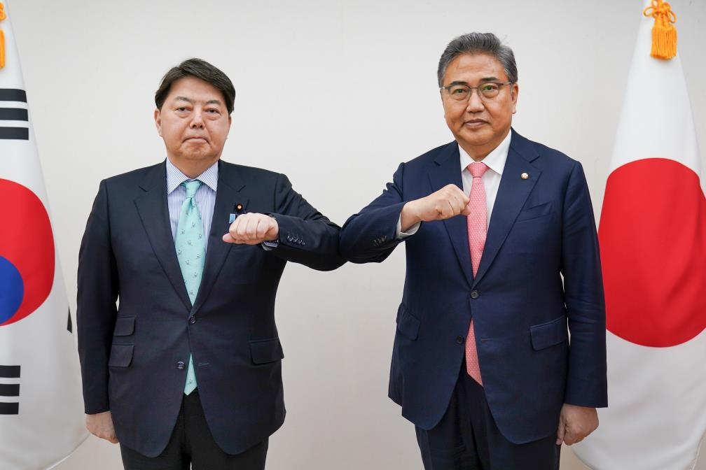 South Korean Foreign Minister nominee Park Jin (R) and Japanese Foreign Minister Yoshimasa Hayashi bump elbows during their meeting in Seoul on May 9, 2022, in this photo provided by Seoul's foreign ministry. (PHOTO NOT FOR SALE) (Yonhap)