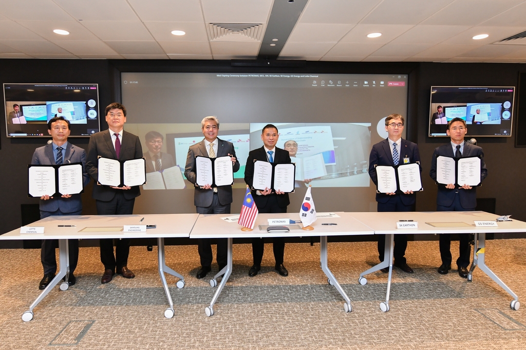 Officials of Lotte Chemical, Samsung Engineering, Petronas, SK Earthon and GS Energy pose for a photo after signing a memorandum of understanding for a project to capture, transport and store carbon dioxide in a virtual meeting in Kuala Lumpur, Malaysia, on Aug. 2, 2022, in this photo provided by SK. (PHOTO NOT FOR SALE) (Yonhap) 