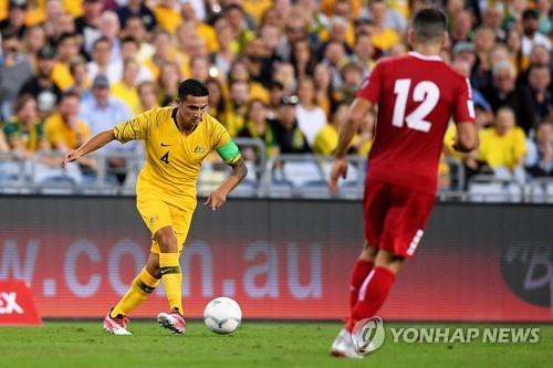 In this EPA file photo from Nov. 20, 2018, Tim Cahill of Australia (L) controls the ball against Lebanon during his final international match at Sydney Olympic Stadium in Sydney. (Yonhap)