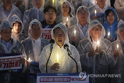 Lee Jae-myung (C), chair of the Democratic Party, speaks during a candlelight rally denouncing Japan's plan to release treated radioactive water at the National Assembly in Seoul on Aug. 23, 2023. (Yonhap)