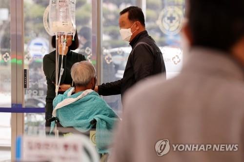 A patient and his family members move at a hospital in the southwestern city of Gwangju on March 26, 2024. (Yonhap)