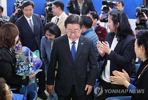 Lee Jae-myung (C), head of the main opposition Democratic Party and a candidate in the Gyeyang-B district in Incheon, 27 kilometers west of Seoul, is at his election office on April 11, 2024, amid forecasts by TV exit polls of his party's landslide victory in the general elections the previous day. (Pool photo) (Yonhap)