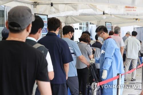 Des personnes font la queue pour subir un test de dépistage du nouveau coronavirus (Covid-19) au centre médical public de Mapo, dans l'ouest de Séoul, le jeudi 11 août 2022. 