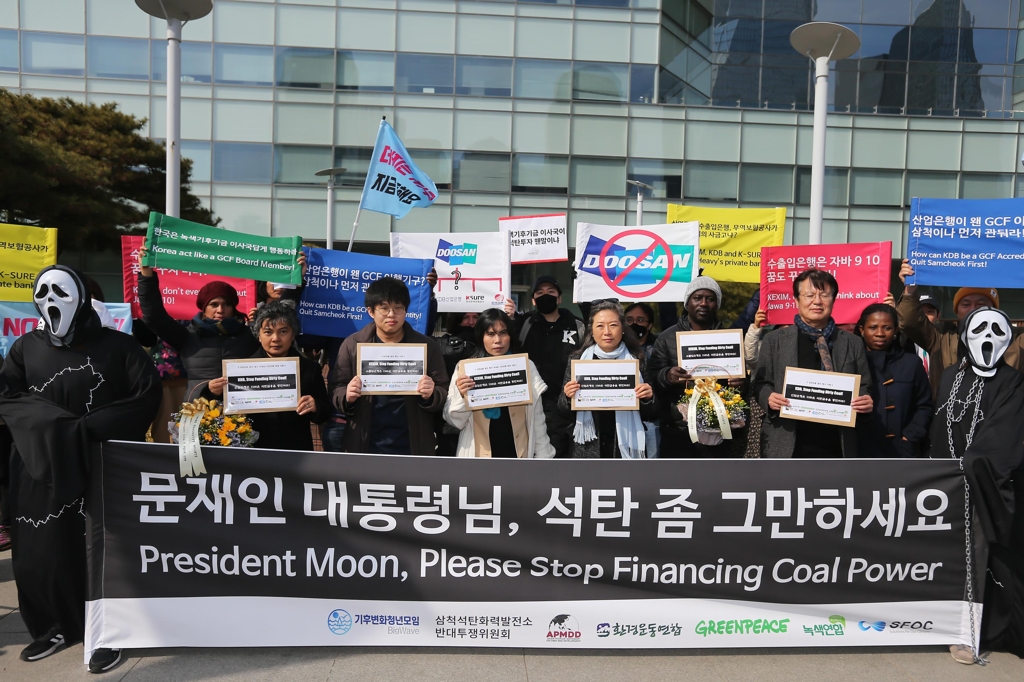환경단체 활동가들이 25일 서울 여의도 산업은행 앞에서 석탄 산업 투자를 멈추라며 정부를 비판하고 있다. [GSCC 제공=연합뉴스]
