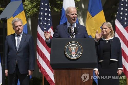 US President Joe Biden (center) giving a speech