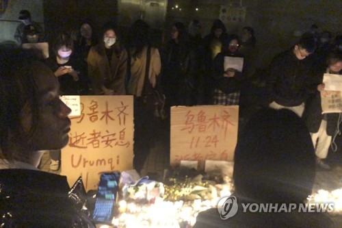 (상하이 AP=연합뉴스) 지난 26일 중국 상하이에서 신장 우루무치 화재 희생자를 추모하는 시위가 벌어졌다. 